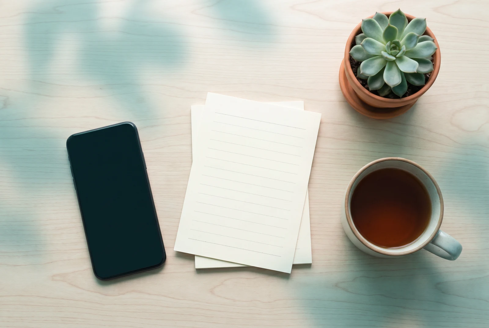 A phone kept beside a notebook